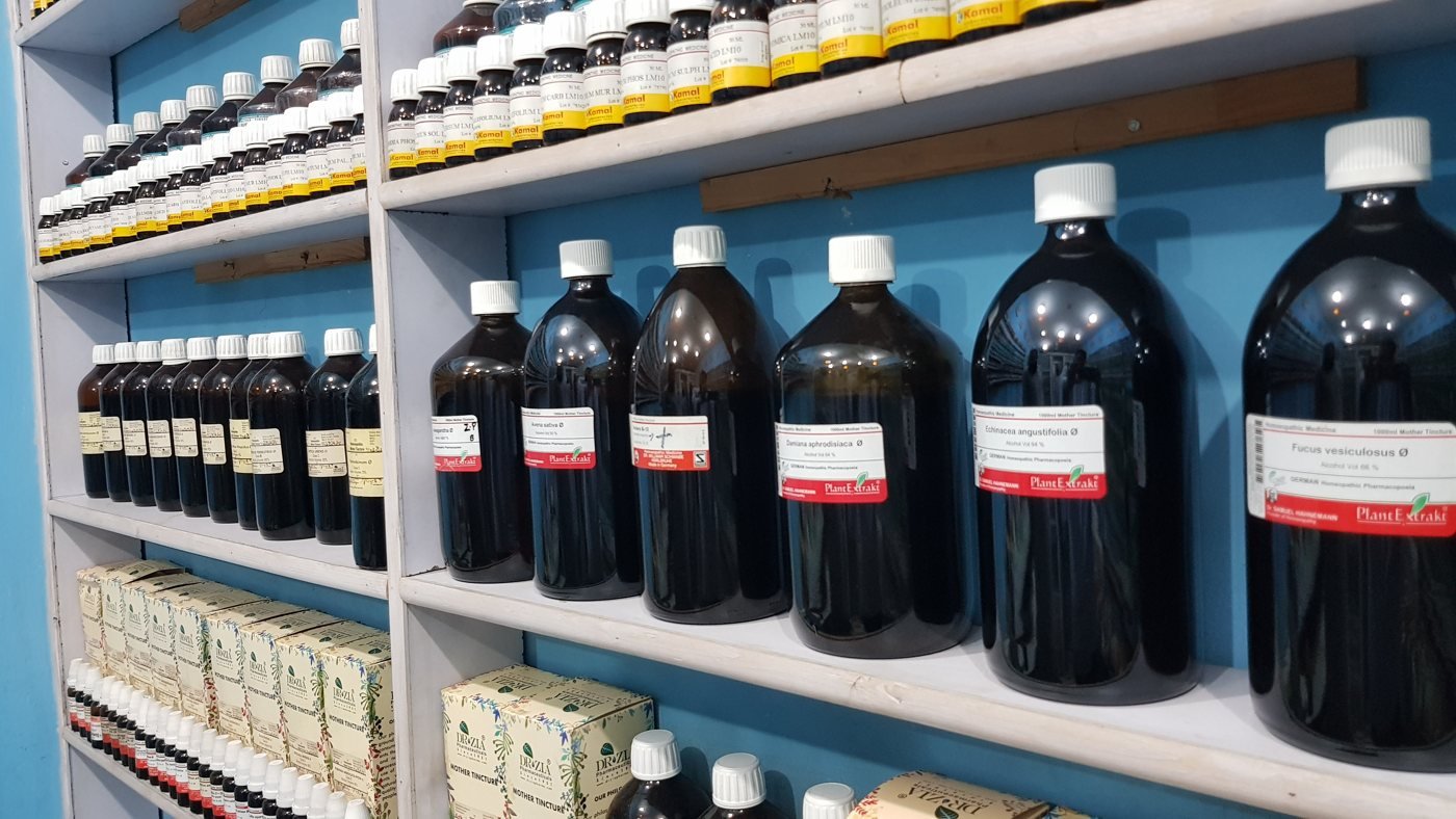 Shelves of mother tinctures and LM-potency bottles in the clinic dispensary